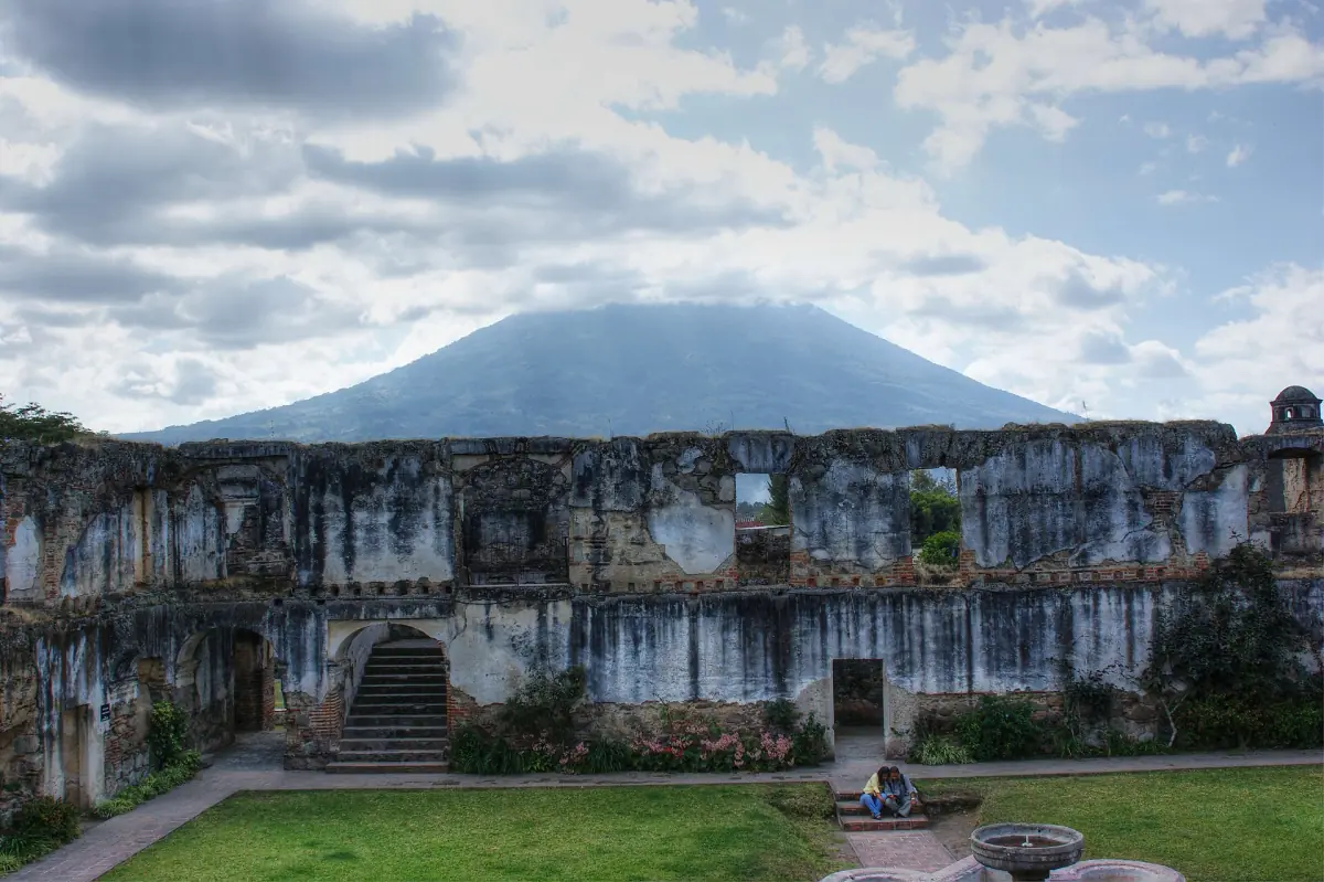 Colonial church ruins in Antigua with a volcano behind